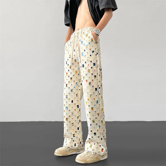 Men's edgy ripped patchwork pants, a unique distressed design for urban streetwear style.