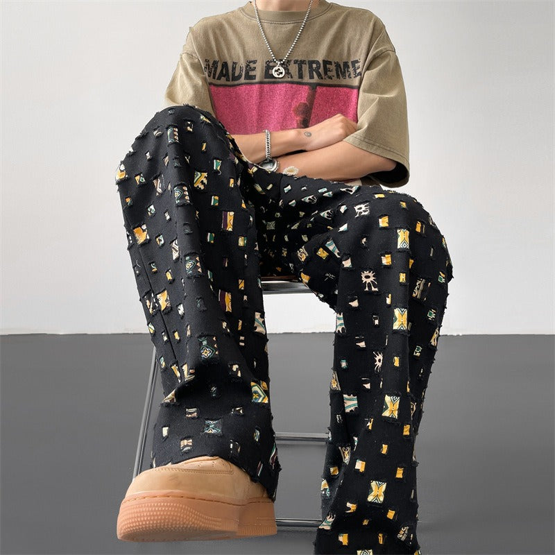 Versatile men's casual pants with an edgy ripped and patchwork look, perfect for a contemporary urban style.