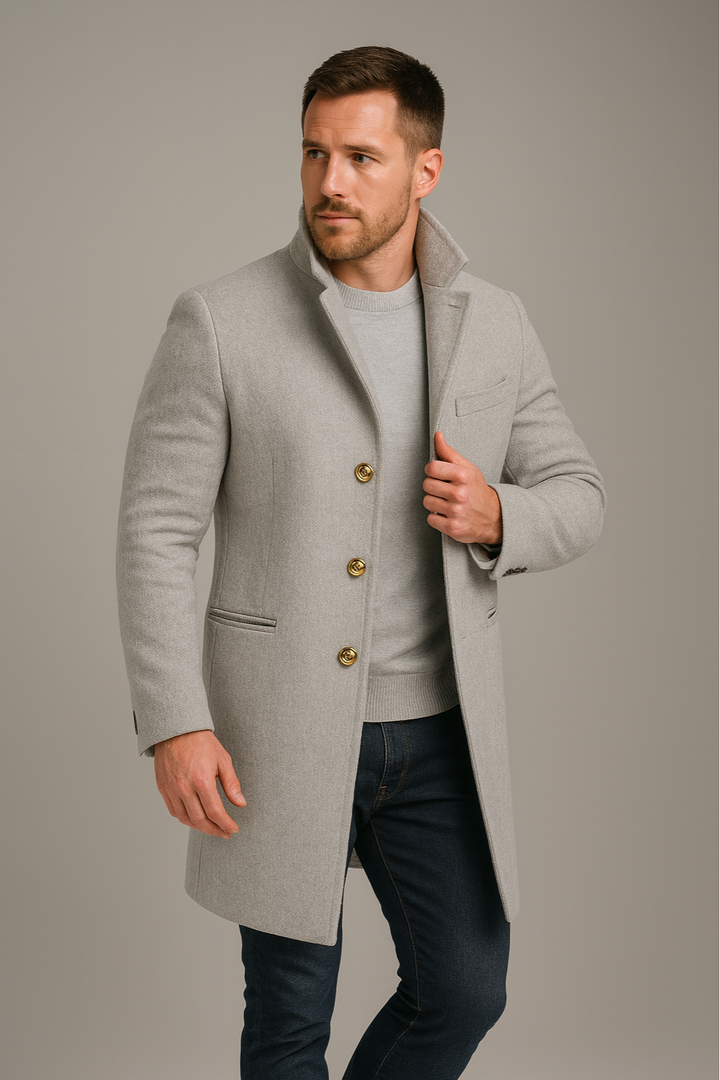 Sophisticated men's black long trench coat with prominent gold buttons, a refined piece for fall & winter fashion.