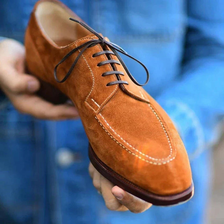 Close-up of durable, high-quality brown leather on men's classic oxford shoes for refined fashion.