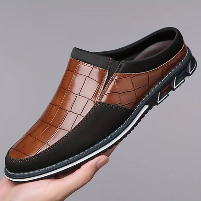 Men's fashion footwear: sleek embossed slip-on mules for modern gentlemen.