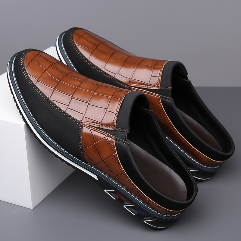 Side view of men's comfortable embossed slip-on mules with a sturdy grip sole.