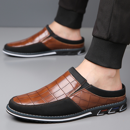 Top view of elegant men's embossed slip-on mules; easy wear, stylish design.