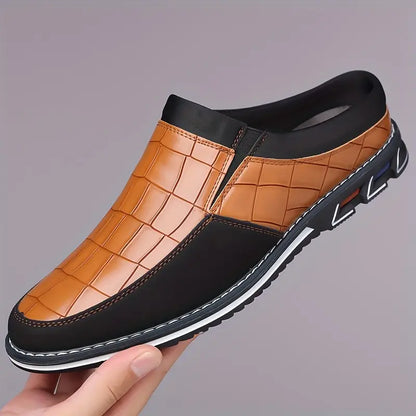 Detailed view of grip sole on men's embossed slip-on mules, ensuring stability.