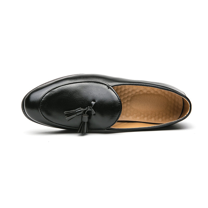 Side view of classic men's polished tassel loafers, elegant slip-on shoes for sophisticated formal & casual wear.