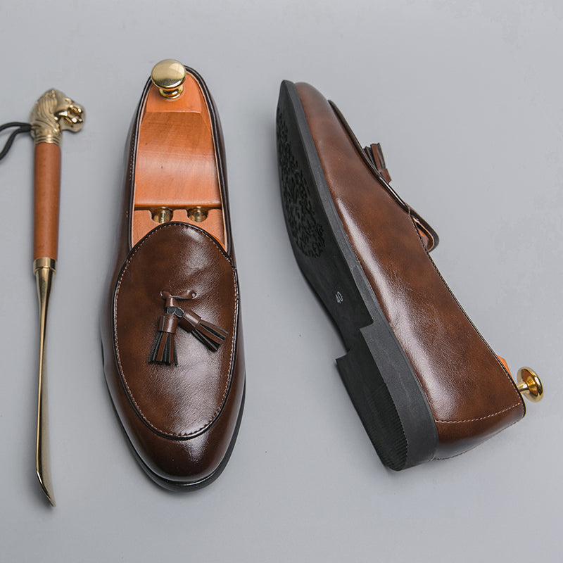 Classic men's polished tassel loafers, versatile for formal or casual wear, offering slip-on elegance & comfort.