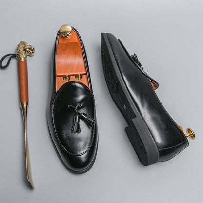 Men's polished leather tassel loafers featuring decorative tassels, a classic elegant slip-on for formal fashion.