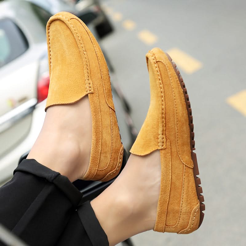 Men's fashion loafers paired with trousers, showcasing versatile slip-on style for any occasion.