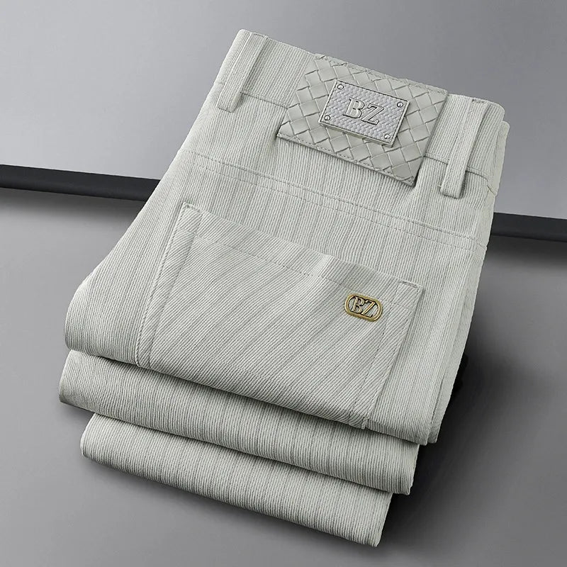 Stylish man wearing elegant striped business trousers, showcasing a professional yet comfortable office look.