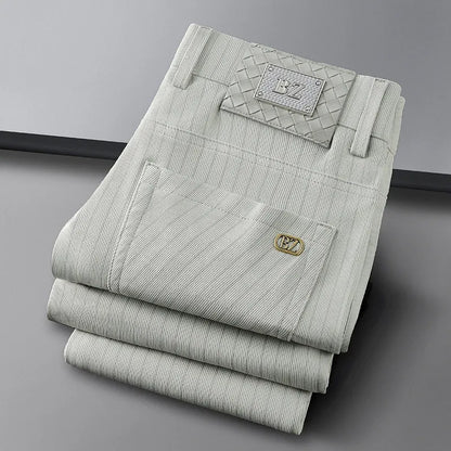 Stylish man wearing elegant striped business trousers, showcasing a professional yet comfortable office look.