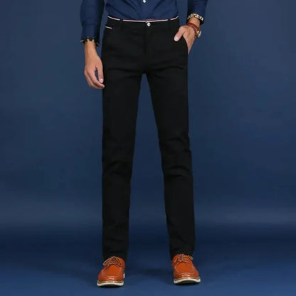 Man wearing Elite Slim Fit Dress Pants with a sharp blazer, looking confident & professional for work.