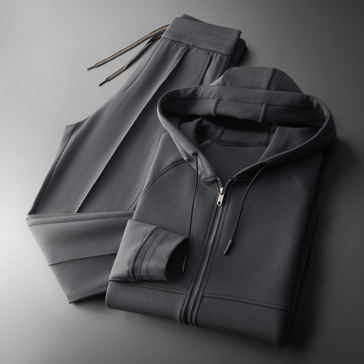 Man jogging in an elite men's tracksuit set, perfect activewear for ultimate comfort & sport outfit.