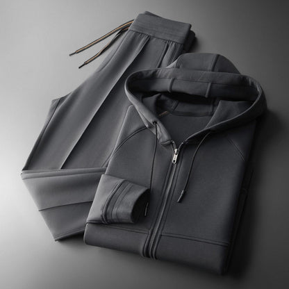 Man jogging in an elite men's tracksuit set, perfect activewear for ultimate comfort & sport outfit.
