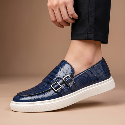 Embossed men's slip-on loafers with platform sole and a decorative buckle, a stylish footwear choice.
