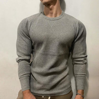 Close-up of a men's performance muscle shirt, showcasing breathable athletic fabric and a fitted design.