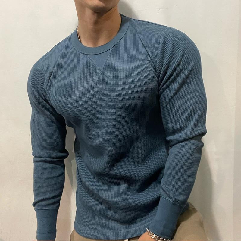 Athletic man stretching in a comfortable performance muscle shirt, ideal for gym and active lifestyle.