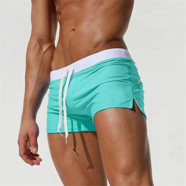Sleek men's fitted swim trunks with quick-dry technology, ideal for modern beach look.