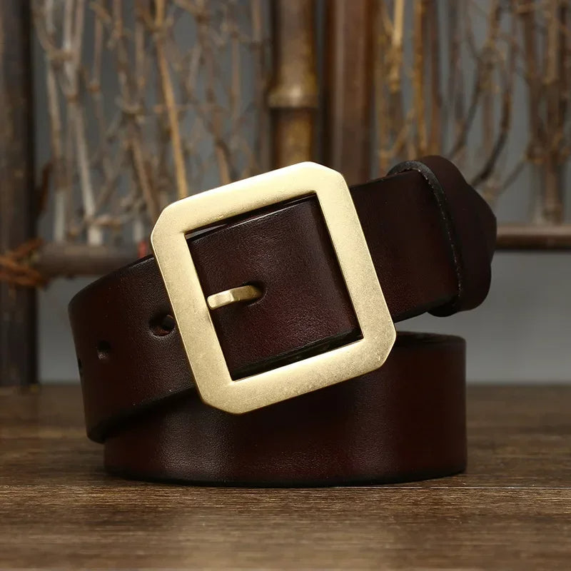Close-up of a men's full-grain leather belt featuring a sturdy, timeless solid brass buckle detail.