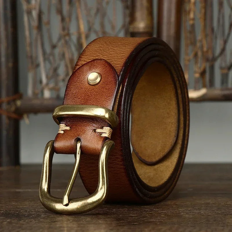 Full-grain leather belt for men, featuring a polished brass buckle, embodying timeless men's style.