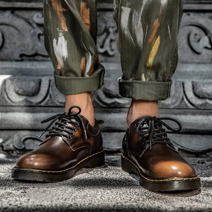 Comfortable brown genuine leather low-cut shoes for men. Versatile casual kicks with a round toe.