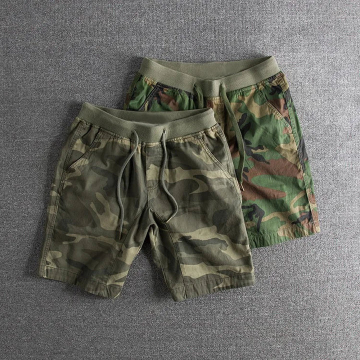 Stylish men's camo shorts with gray & green pattern, designed for comfortable activewear and outdoor versatility.