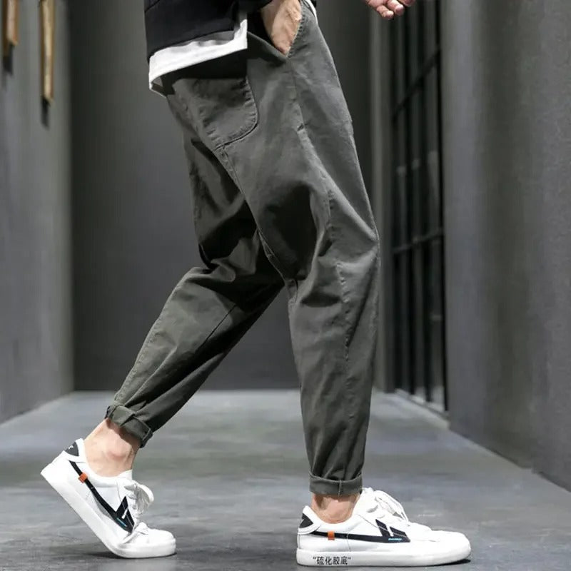 Man walking in tapered joggers outdoors, ideal for athleisure, casual wear, and comfortable everyday style.