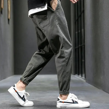 Man walking in tapered joggers outdoors, ideal for athleisure, casual wear, and comfortable everyday style.