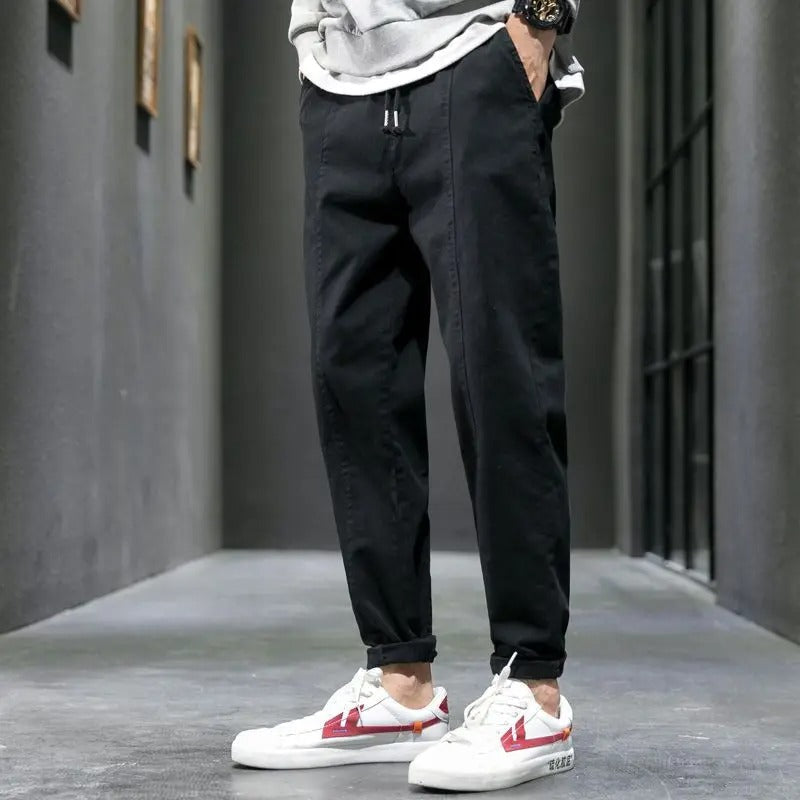 Man relaxing in comfortable tapered joggers, perfect loungewear and casual wear for ultimate comfort.