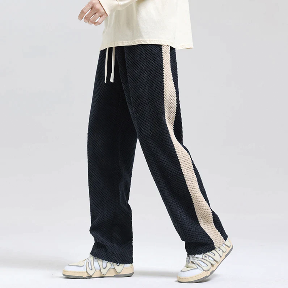 Athletic-fit men's black corduroy joggers with waffle knit texture, ideal for everyday comfort.