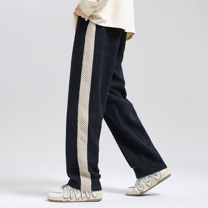 Textured black men's waffle knit corduroy pants, offering both a modern look and ultimate comfort.