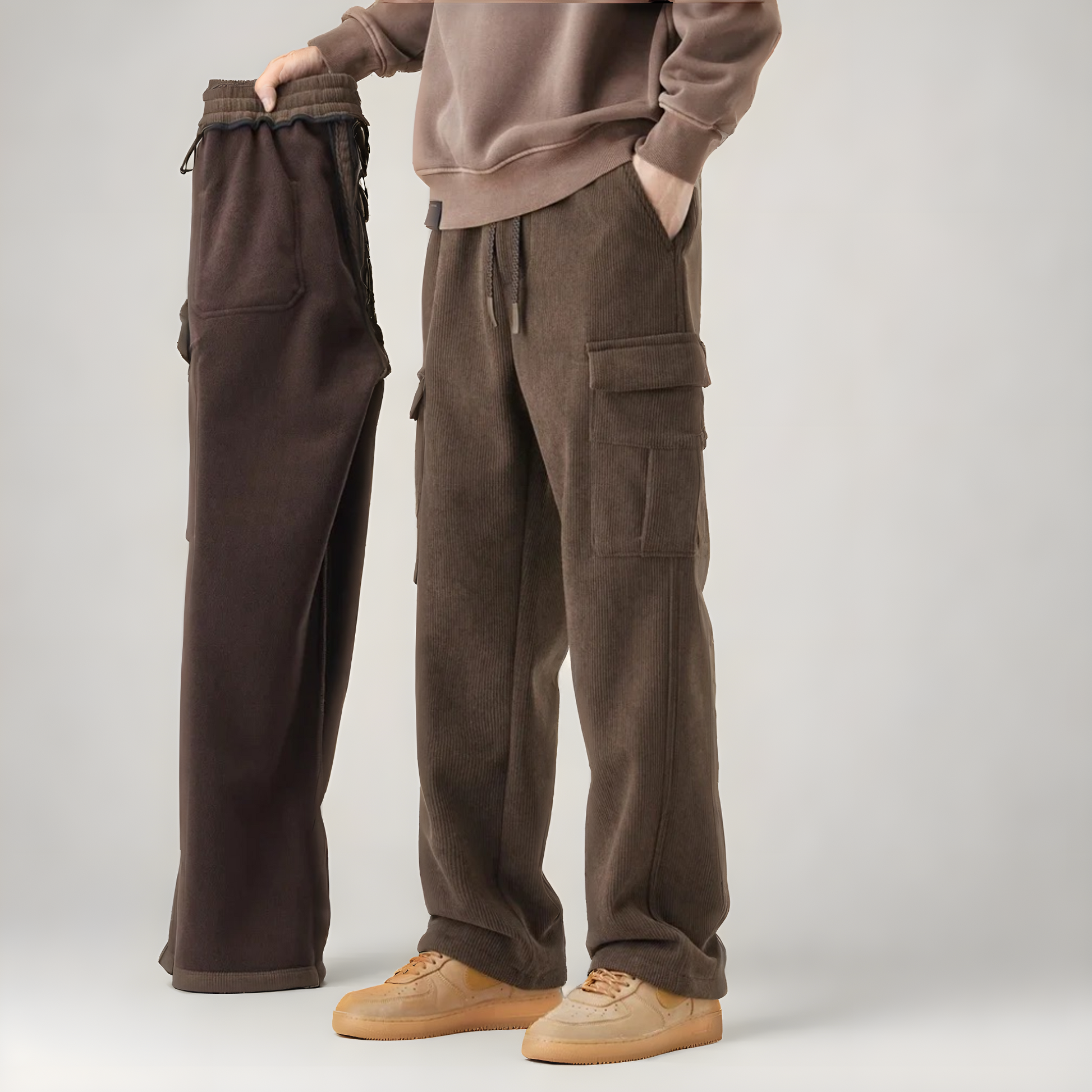 Man wearing relaxed fit men's cargo sweatpants, demonstrating comfort & flexibility for active or casual wear.