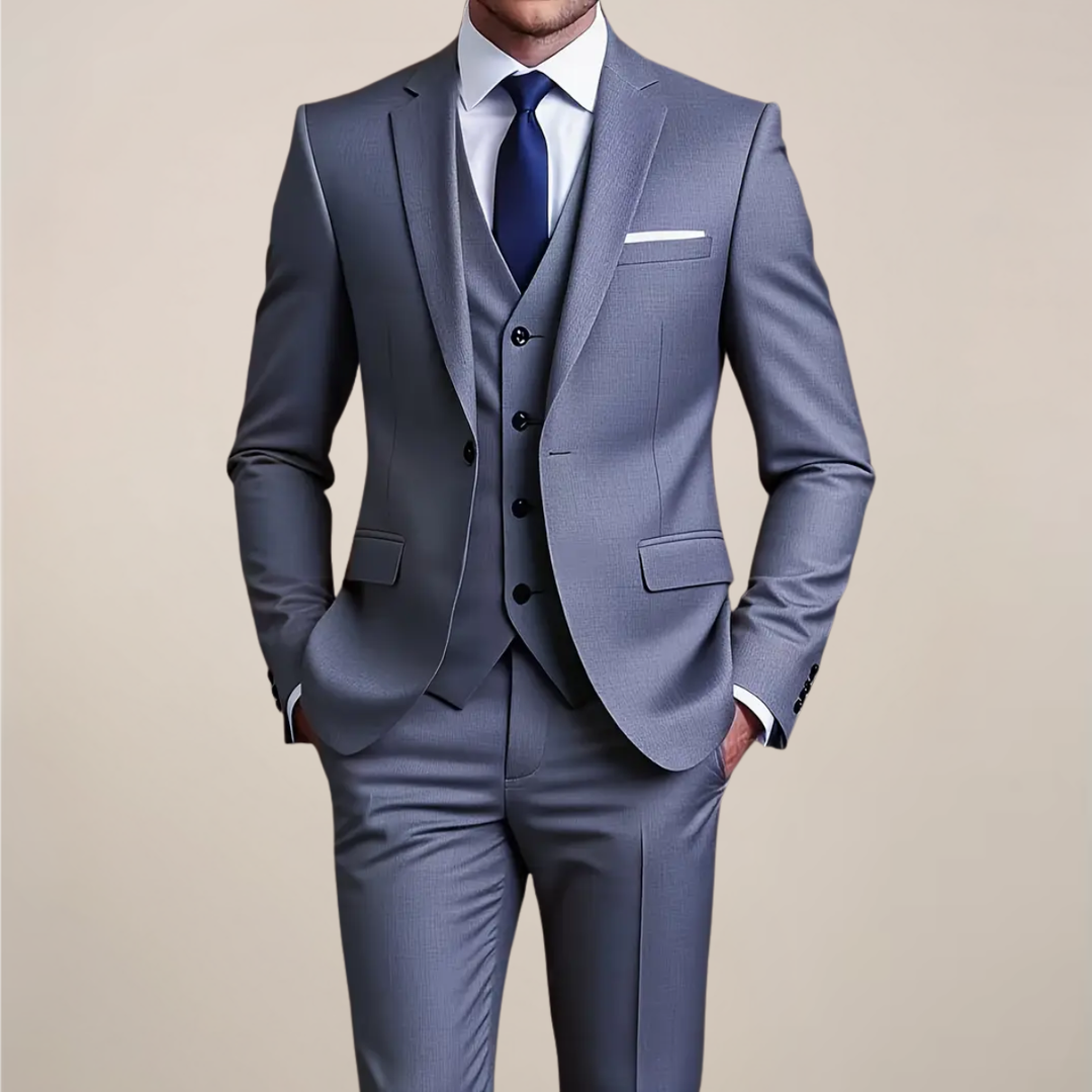 Men's grey slim fit three-piece suit, ideal for weddings & formal events. Includes jacket, vest, & trousers.