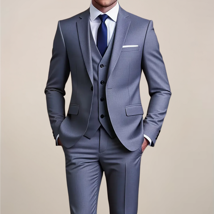 Men's grey slim fit three-piece suit, ideal for weddings & formal events. Includes jacket, vest, & trousers.