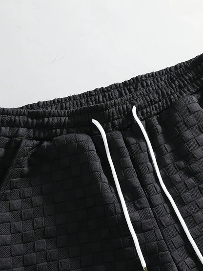 Man wearing a relaxed gridline checkered lounge set, showcasing comfortable two-piece homewear for summer.