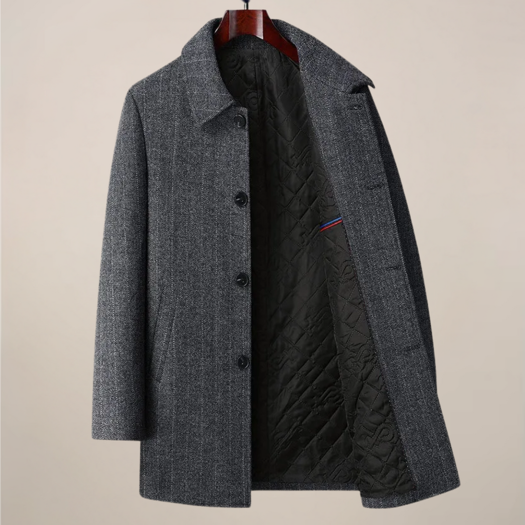 Close-up of men's herringbone car coat fabric, showcasing the detailed pattern and quality textile.