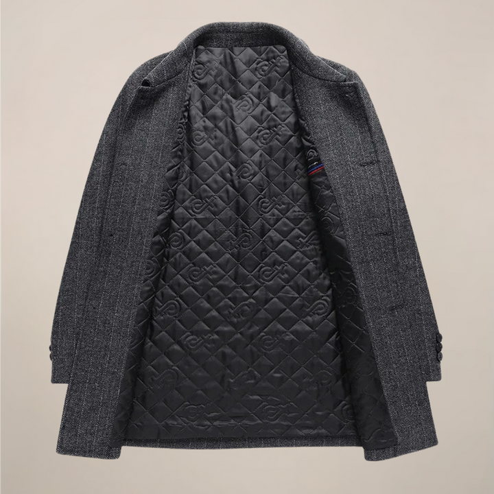 Man wearing a stylish herringbone car coat over a suit, ideal for business or smart casual fall outerwear.