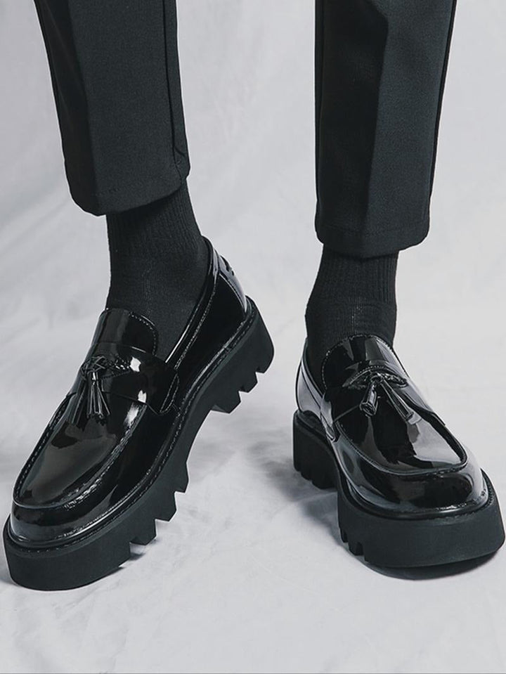 Classic men's black tassel loafers with a trendy chunky sole, ideal as comfortable dress shoes & formal footwear.