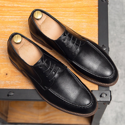 Detail shot of the polished toe on Men's Hudson black leather lace-up dress shoes, sophisticated professional footwear.