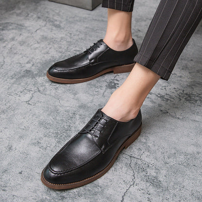Pair of Men's Hudson classic black polished lace-up dress shoes, essential formal and business footwear.