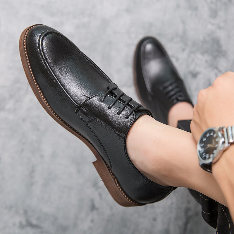 Angled shot of Men's Hudson professional black polished leather lace-up dress shoes, classic business style.