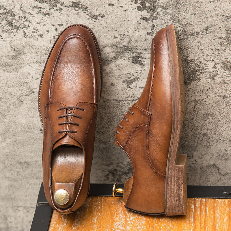 Close-up of classic lace-up detail on Men's Hudson black polished leather formal dress shoes, elegant style.