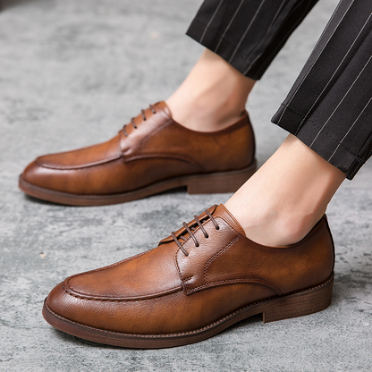 Front view of Men's Hudson black polished formal shoes, classic lace-up style for professional business attire.