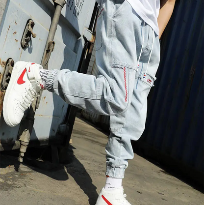 Men's Jacques Tapered Denim Joggers paired with sneakers, highlighting modern look & casual style.