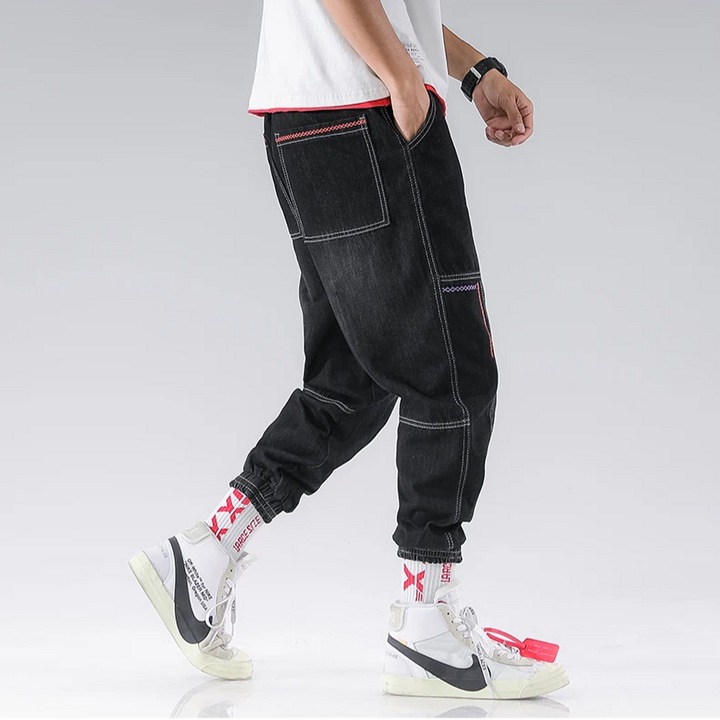 Side view of men's Jacques Tapered Denim Joggers, showcasing modern tapered leg and relaxed fit.