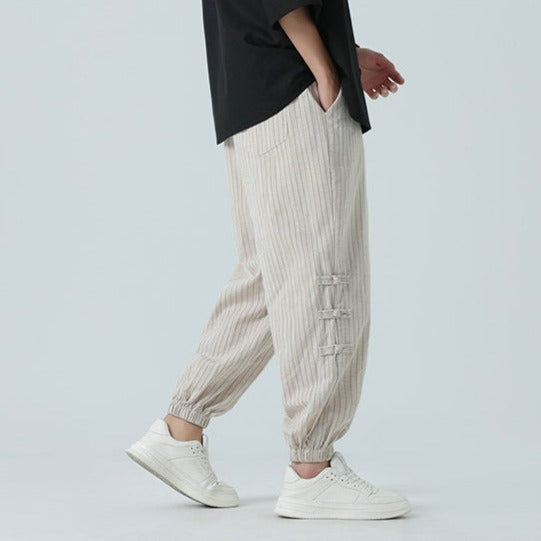 Japanese streetwear men's pants, featuring stylish side stripe detail & a modern loose fit.