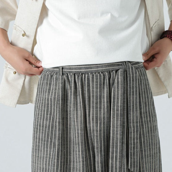 Modern men's loose fit pants with side stripe, embodying Japanese streetwear and urban comfort.