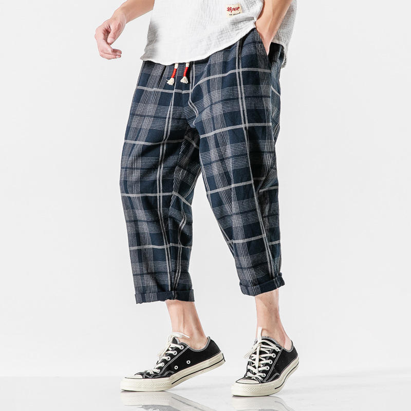 Flowy men's Kaizen Grid Pants with a modern drawstring design, perfect for casual and everyday comfort.
