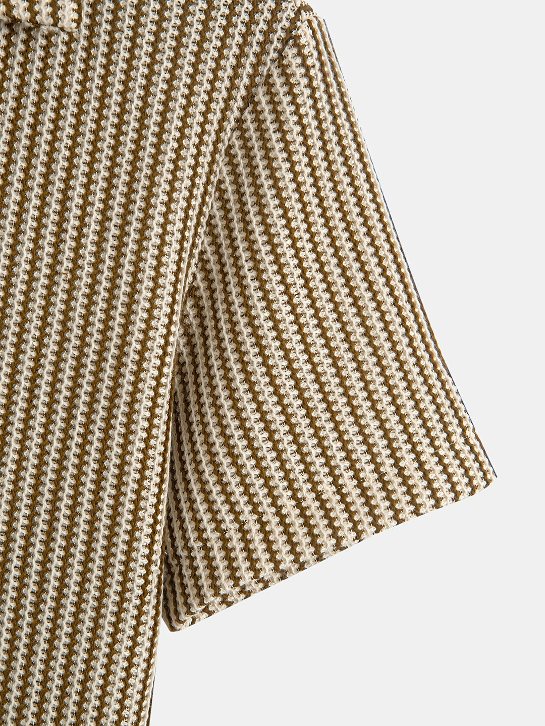 Close-up of men's knit striped short sleeve button-up shirt, showcasing breathable stretch fabric texture.