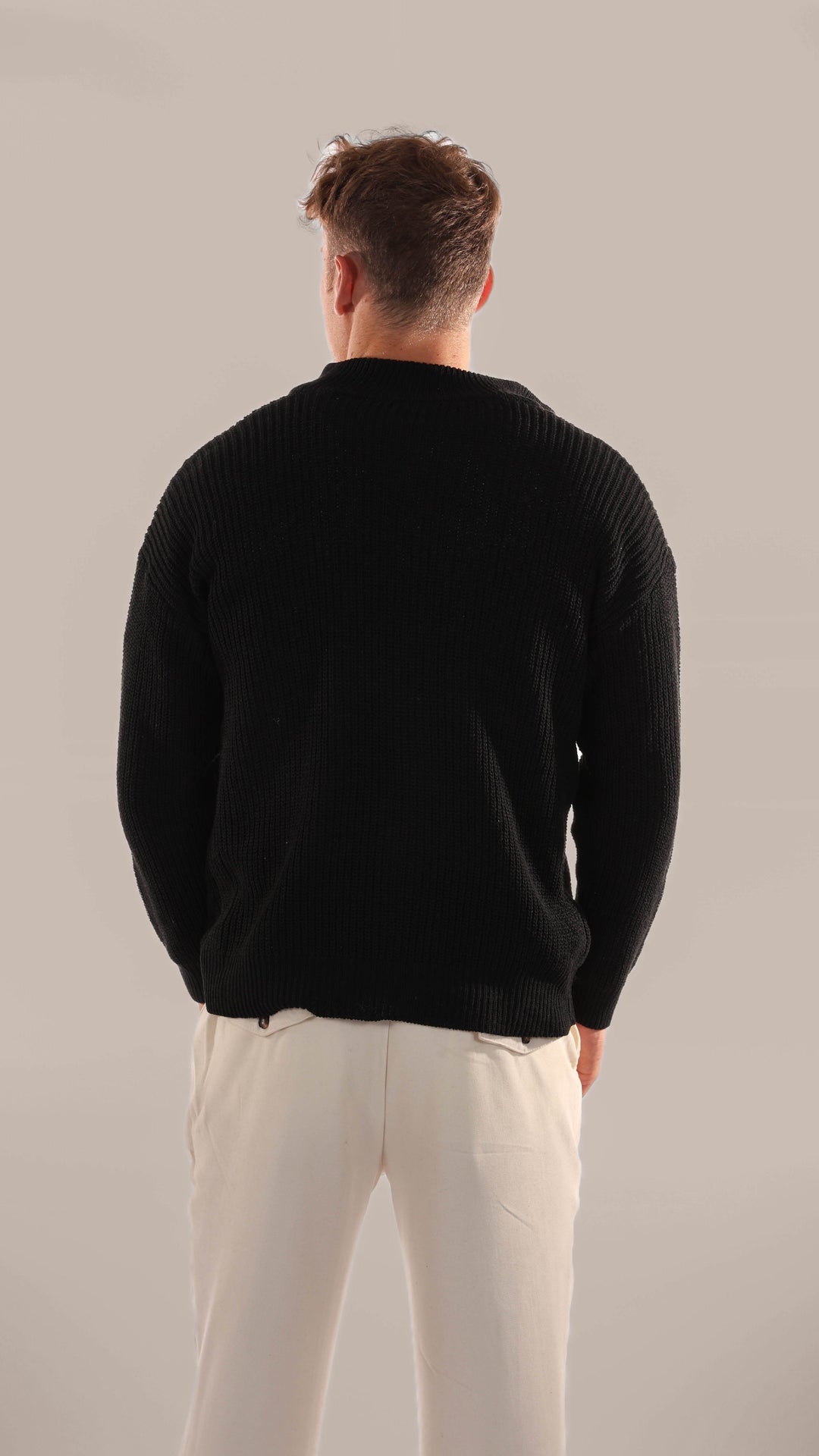 Close-up of the soft knitted texture on a men's half-zip jumper, highlighting quality and comfort for everyday wear.