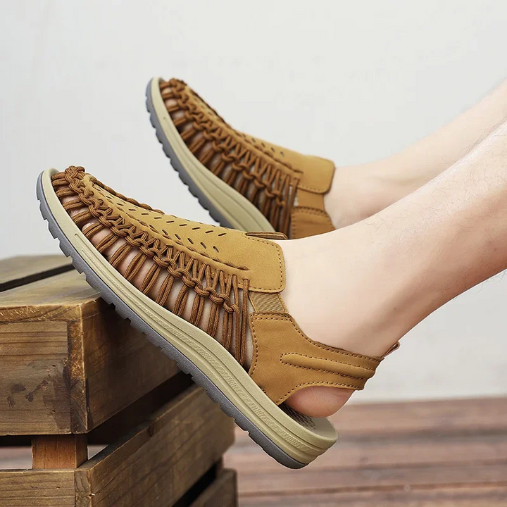 Adjustable men's comfort sandals, featuring a durable braided strap & lightweight sole for outdoor wear.